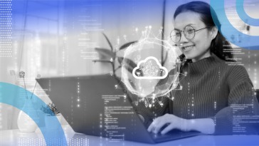 A woman working on a laptop with a holographic symbol of a cloud and various code superimposed over her.