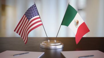 Photo of an American and Mexican flag.