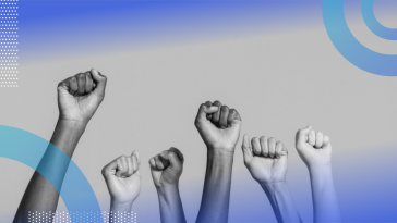 A close-up of six fists raised in solidarity.