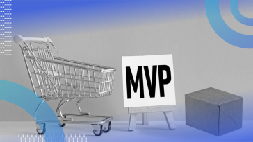 A shopping cart, a white sign on an easel with “MVP” written on the canvas in black block letters and a plain cardboard box.