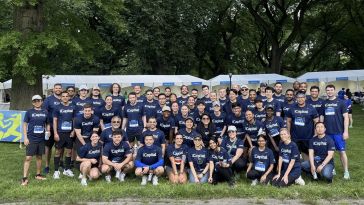 iCapital employees pose for a group picture in matching athletic gear.