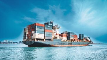 A multicolored cargo ship leaves the port of Chennai.