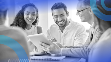 Happy employees are sitting at a table.