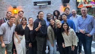 Crafty team members posing for a group photo on an outdoor restaurant patio.