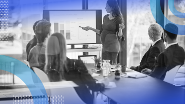 A pregnant woman gives a presentation in a corporate office