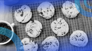 A tray of freshly baked cookies with a cup of coffee