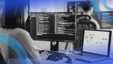 A woman works on multiple computer terminals showing code