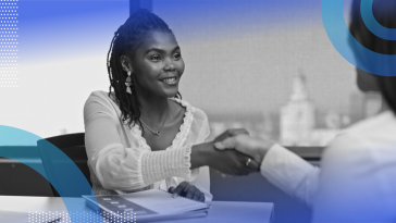 A candidate shaking hands with her interviewer.