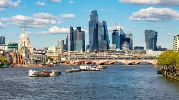 A view of the London skyline featuring Blackfriars Bridge over the River Thames with skyscrapers in the background.