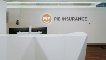 A lit Pie Insurance logo shines in the company’s lobby.