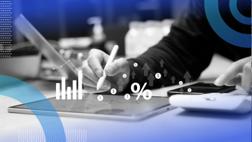 Closeup on hands working on a tablet with graphs and a percentage icon