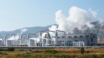 Geothermal energy plant surrounded by mountains.