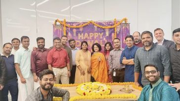 The Cencora team poses for a group photo with celebratory Diwali decorations.