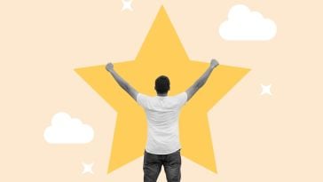 A man holds his hands up in the air with a big yellow star above him.