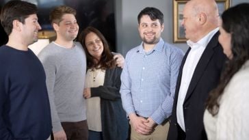 The Rice family smiles at one another in the Energy CX office.