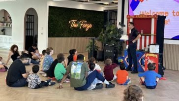 Parents and children sit for a show during Braze’s Take Your Kids to Work Day celebrations.