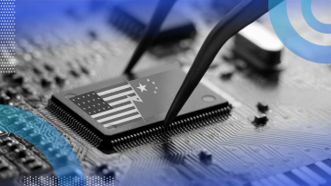 A computer chip is placed on a motherboard with images of the American and Chinese flags on it