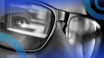 A closeup on the eyes of a developer wearing glasses and looking at code