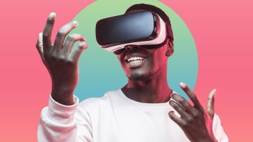 A man wearing a VR headset, holding his hands out.