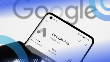 A smartphone with the Google Ads logo in front of the Google logo