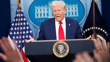Trump stands at a podium in the white house press room.