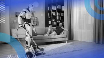 A robot vacuums while a man makes a phone call on the couch