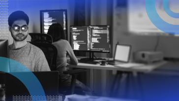 Two software developers work on terminals