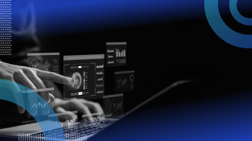 A systems analyst works on a laptop