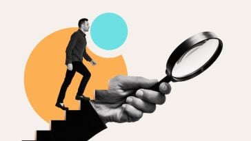 A job applicant climbs up an arm holding a magnifying glass.