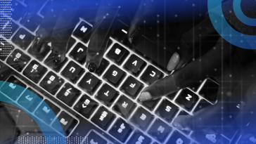 Hands typing on a glowing keyboard