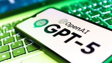 GPT-5 on a smartphone screen resting on a laptop keyboard