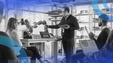 Robotics researchers studying robotic arm