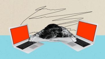 A burned-out worker lays their head between two laptops.