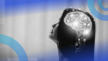 An illuminated brain in a woman's head