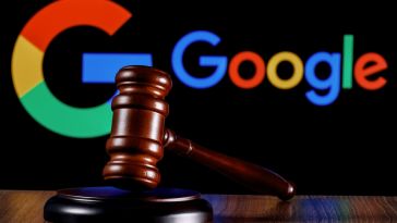 A judge's gavel rests on a table, with Google's logo displayed on a black background.