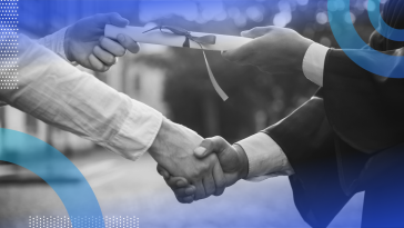A graduate shakes hands and receives a diploma