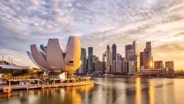 A photo of the Singapore skyline in the Marina Bay area at sunset.