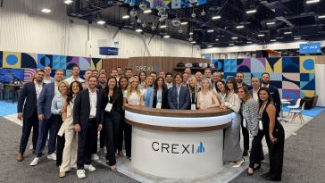 Crexi employees pose for a large group photo during an event