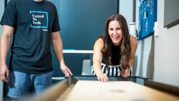 Built In employee playing shuffleboard representing work-life balance