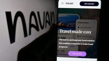 A hand holds a mobile device with the text "Travel made easy" on the screen and the Navan logo in the background of the image.