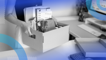 Employee packing up a box and leaving after being laid off