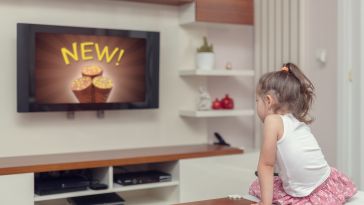 Kid watches ad on TV