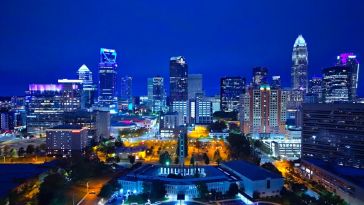 A view of the Charlotte, North Carolina skyline at night featuring several skyscrapers.