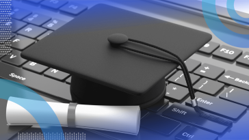 A degree and graduation cap lying on a keyboard