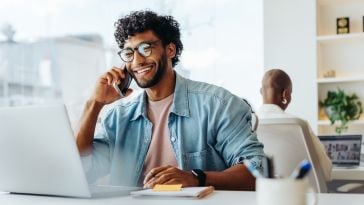 A person speaks on the phone.