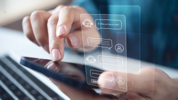 A close up of a pair of hands interacting with a mobile device with an illustration of messages with an AI chatbot hovering over the screen.