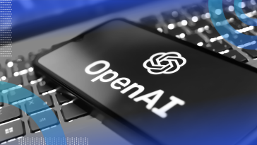 A smartphone with the OpenAI logo on top of a laptop keyboard