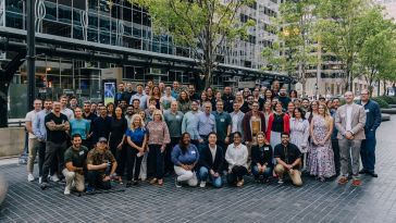 Prolaio team members pose for a large group photo in downtown Chicago