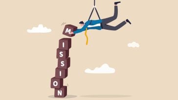 An illustration of a businessman stacking blocks on top of each other that spell out the word “mission,” symbolizing the idea of employees building a company’s mission