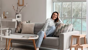 A person lounges in a living room